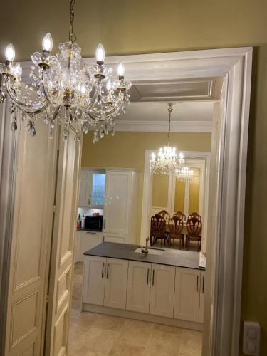 a kitchen with a chandelier and a dining room at Chateau de Briand in Luxé