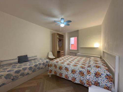 a bedroom with a bed and a ceiling fan at 5 Terre in Lerici