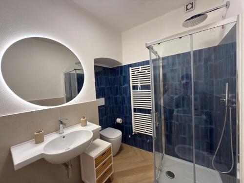 a bathroom with a sink and a glass shower at 5 Terre in Lerici