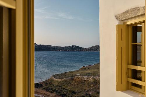 a window with a view of a body of water at Amorgina in Amorgos