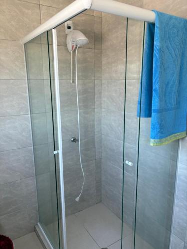 a shower with a glass door in a bathroom at Suite Privativa in Dom Pedrito