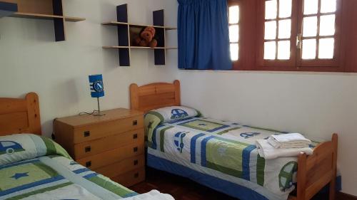 a bedroom with two beds and a girl in a window at CasaLalla - Natura&Relax in Cusano Mutri