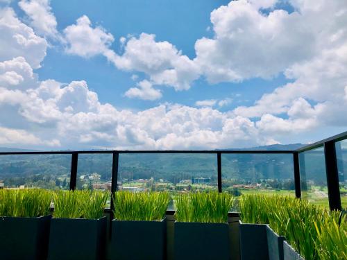 a field of grass with a view of a city at GV Aparta Suites - Centro Chía in Chía