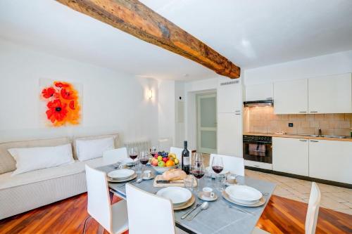 a kitchen and living room with a table and chairs at Palazzo Gritti in Morcote