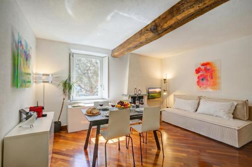 a living room with a table and a couch at Palazzo Gritti in Morcote