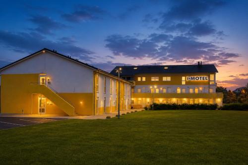 a large building with a staircase in front of it at i-Motel Obertshausen nahe Frankfurt in Obertshausen