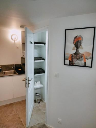 a door to a kitchen with a painting on the wall at Cosy Appartement Hyper Centre-Ville in Quimper