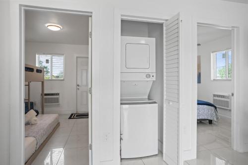 a white room with a kitchen and a living room at 11432 Lincoln Blvd in Richmond Heights