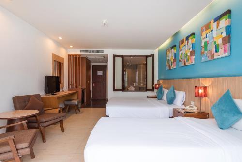 Postel nebo postele na pokoji v ubytování Hotel J Pattaya
