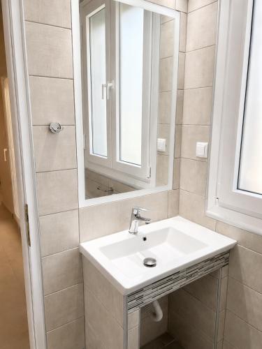 a bathroom with a sink and a mirror at Studios Chrissi-Renovated 2026, Just 20m from the Beach in Skala Sotiros