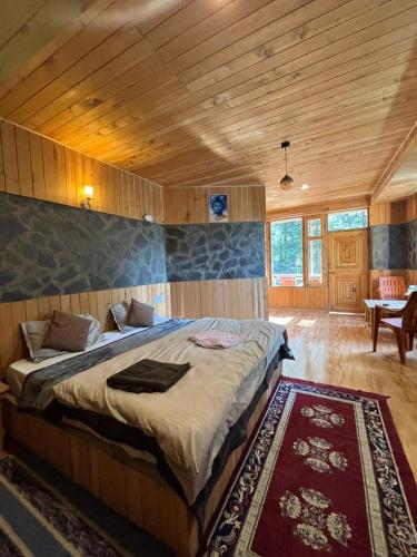 a bedroom with a large bed in a room at Trio Nest in Jibhi