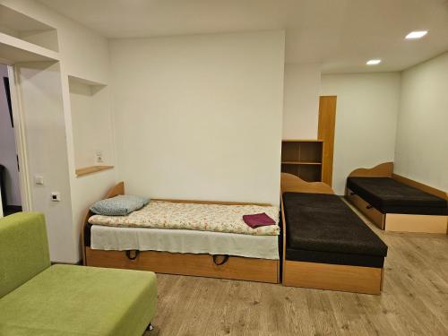 a small room with two beds and a couch at Centro bustas in Kėdainiai