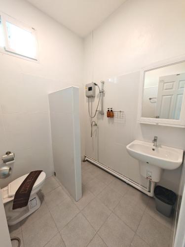 a white bathroom with a toilet and a sink at The paperwhite poolvilla khaoyai in Ban Tha Chang