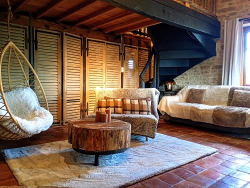 a living room with a chair and a coffee table at Art'Hotel & SPA Le Potin Gourmand in Cluny