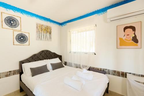 a bedroom with a bed and a window at pRETTy Home with Private Pool, Sea View in Nea Kallikrateia