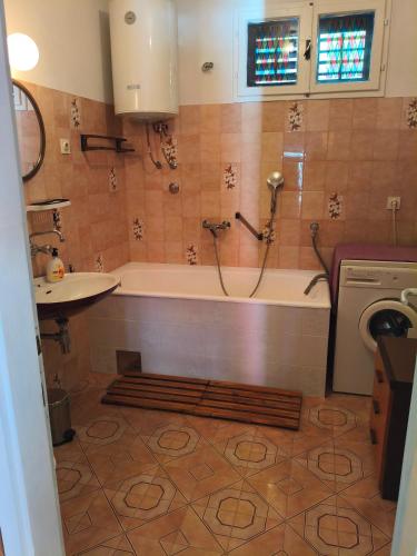 a bathroom with a tub and a sink at Nice postion, belle vue in Pučišća
