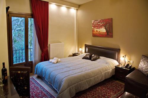 a bedroom with a bed and a window at Hotel Filoxenia in Portaria