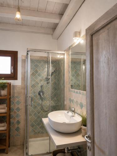 a bathroom with a sink and a shower at Appartamento il Caracolo a Cala Francese in La Maddalena