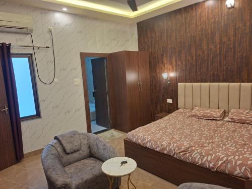 a bedroom with a bed and a chair and a window at Prem niwas in Kakarmatha