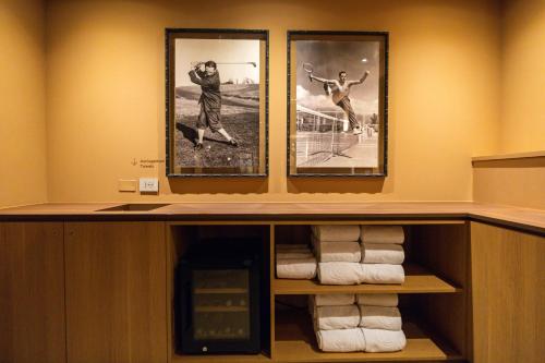 a room with three pictures of two tennis players at QC Room Milano Porta Romana in Milan