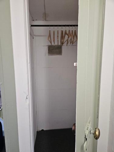 a white closet with a bunch of shoes on a door at Quirky hideout in town centre in Wimborne Minster