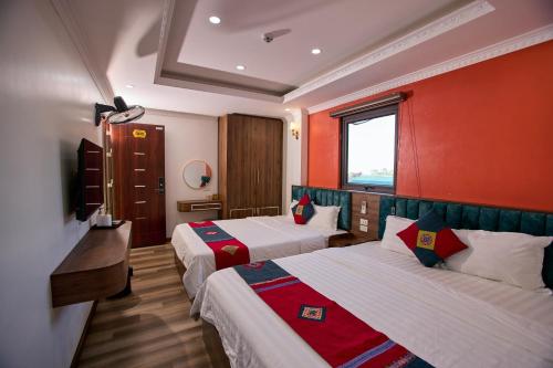 a hotel room with two beds and a window at Harmony Haven Hotel in Sapa