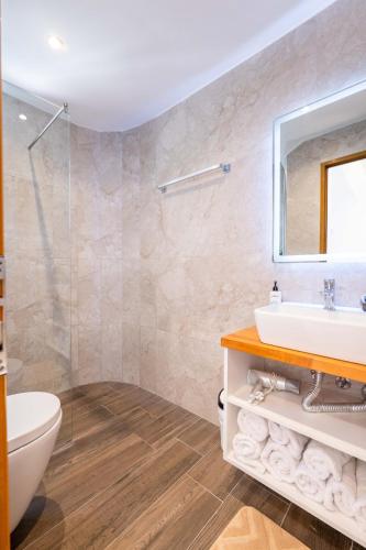 a bathroom with a sink and a mirror at Hotel ENAD in Ksamil