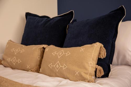 a group of pillows sitting on a bed at Stylish City Centre Studio, Sleeps 2 in Sheffield