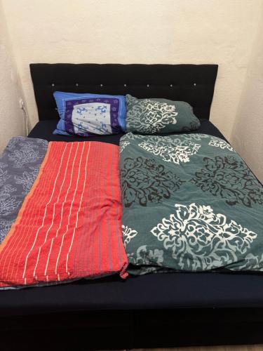 a bed with three pillows on it withthritisthritisthritisthritisthritisthritisthritis at Monteur- & Gästewohnung Coswig in Coswig
