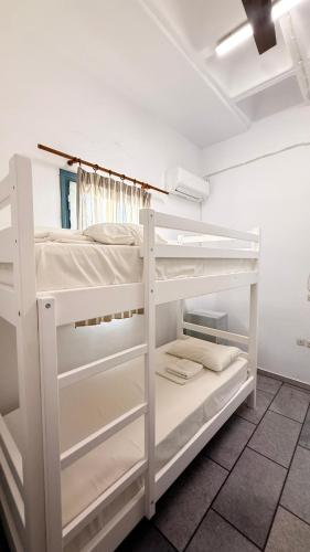 a white bunk bed in a white room at Naxos City Hostel in Naxos Chora