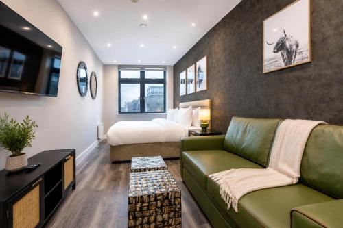 a hotel room with a bed and a couch at The Orpington View in Orpington