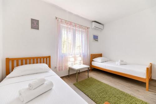 a bedroom with two beds and a window at Villa Bella in Kruševo