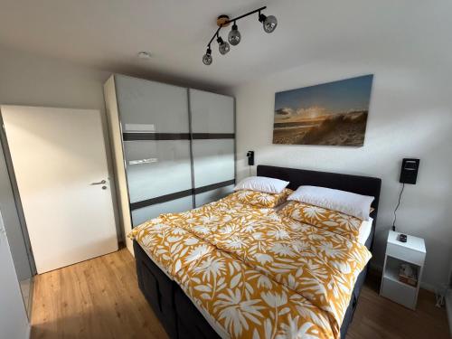 a bedroom with a bed with a comforter on it at Ferienwohnung Janni in Bad Zwischenahn