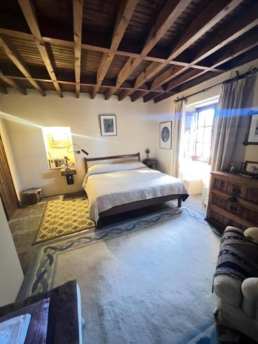 a bedroom with a bed and a couch in it at Herdade Do Vale Coelheiro in Toulões