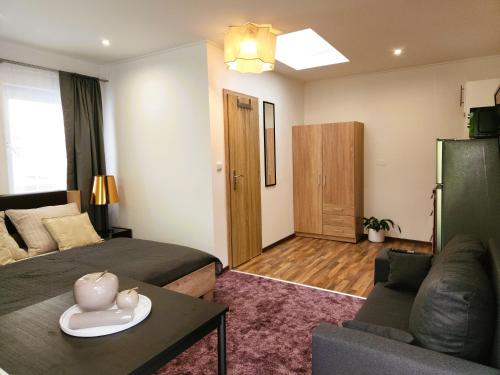 a living room with two beds and a couch at Apartment v podzámčí in Františkovy Lázně