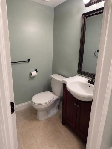 a bathroom with a toilet and a sink at Sunny Home B&B in Charlottetown