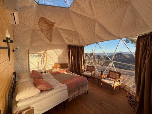 a bedroom with a bed and a large window at Trichk Resort in Goris