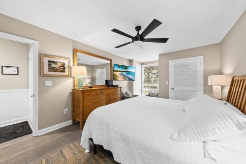 a bedroom with a bed and a ceiling fan at 1325 Pelican Watch Villa in Seabrook Island