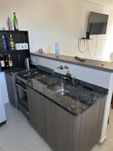 a kitchen with a sink and a stove at Shackleton in Wilde