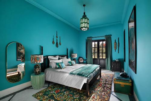 a blue bedroom with a bed and a rug at Villa Samadhi - Luxury & Serenity in Marrakesh