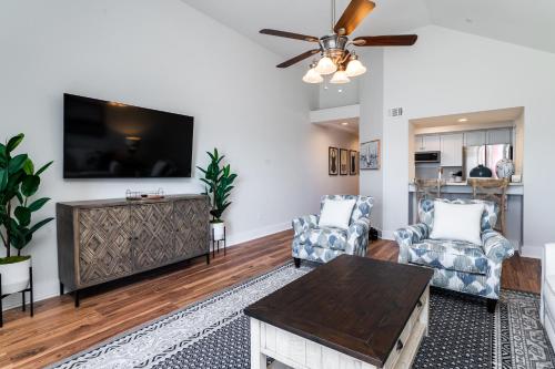 a living room with a flat screen tv on a wall at 1306 Pelican Watch Villa in Seabrook Island