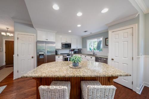 a kitchen with a island with a counter top at 2501 Chateau by the Green in Seabrook Island
