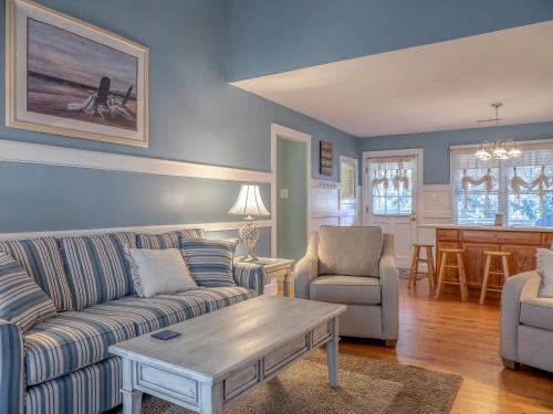 a living room with a couch and chairs and a table at 550 Tarpon Pond Cottage in Seabrook Island