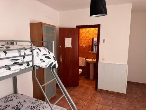 a small room with a bunk bed and a bathroom at Camping Riba-roja in Riba-roja d'Ebre