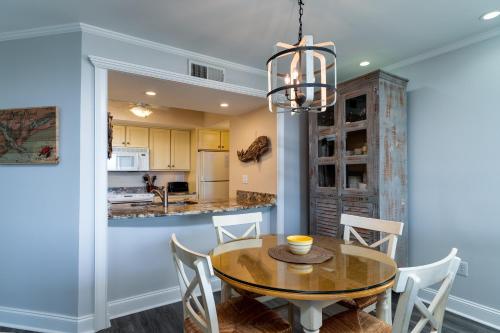 a kitchen and dining room with a table and chairs at 1385 Pelican Watch Villa in Seabrook Island