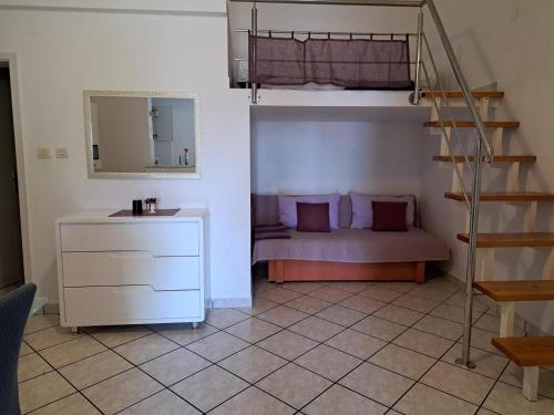 a bedroom with a bunk bed and a staircase at Apartments Rose in Stanići