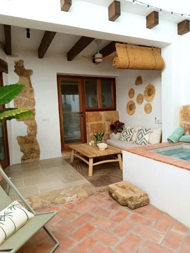 a patio of a house with a table and a bench at Ca La Portella in Jávea