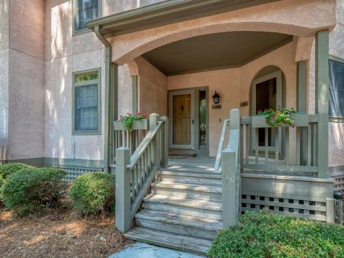a home with a staircase leading to the front door at 2502 Chateau by the Green in Seabrook Island