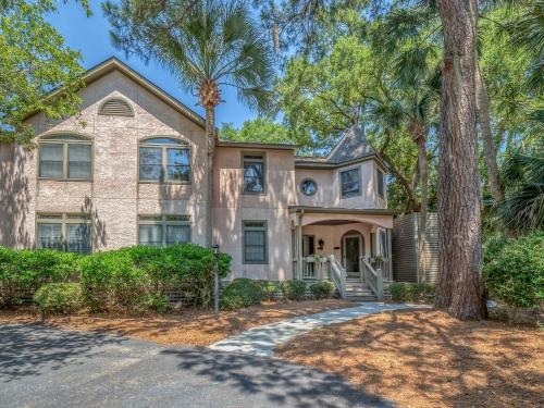 a house with palm trees in front of it at 2502 Chateau by the Green in Seabrook Island