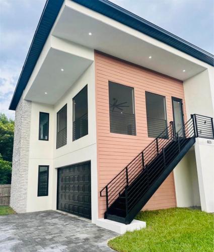 a house with a staircase on the side of it at The Sunshine Studio - No Smoking in Orlando